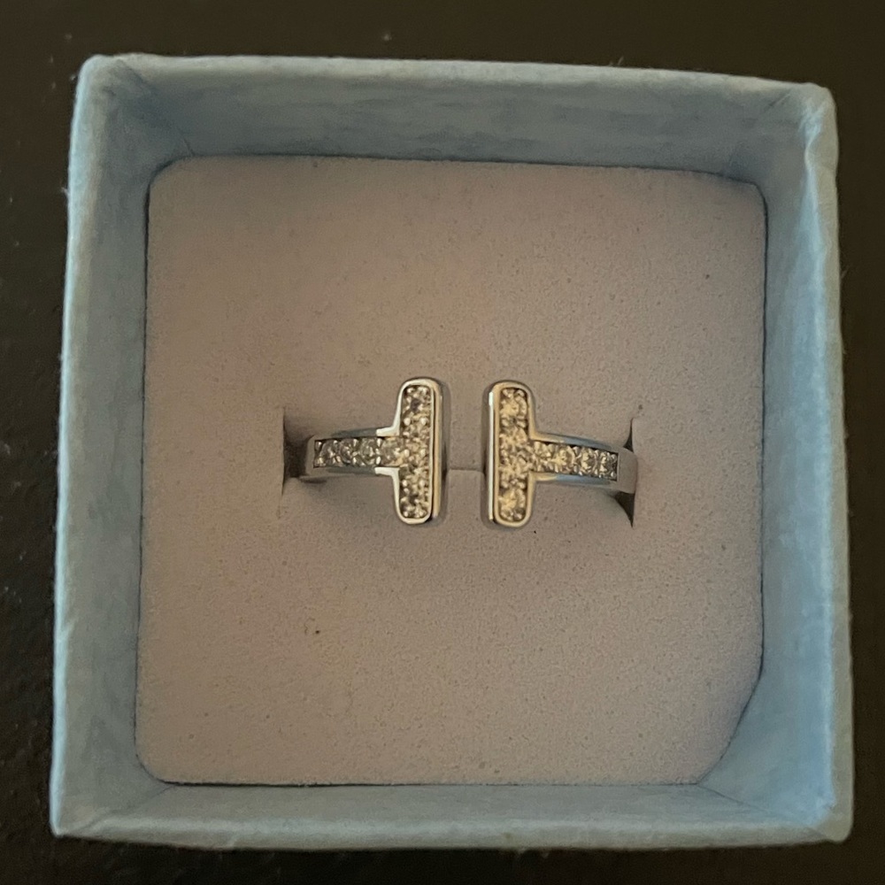 T ring with brilliant CZ. 18k white gold plated . Adjustable size 6-8